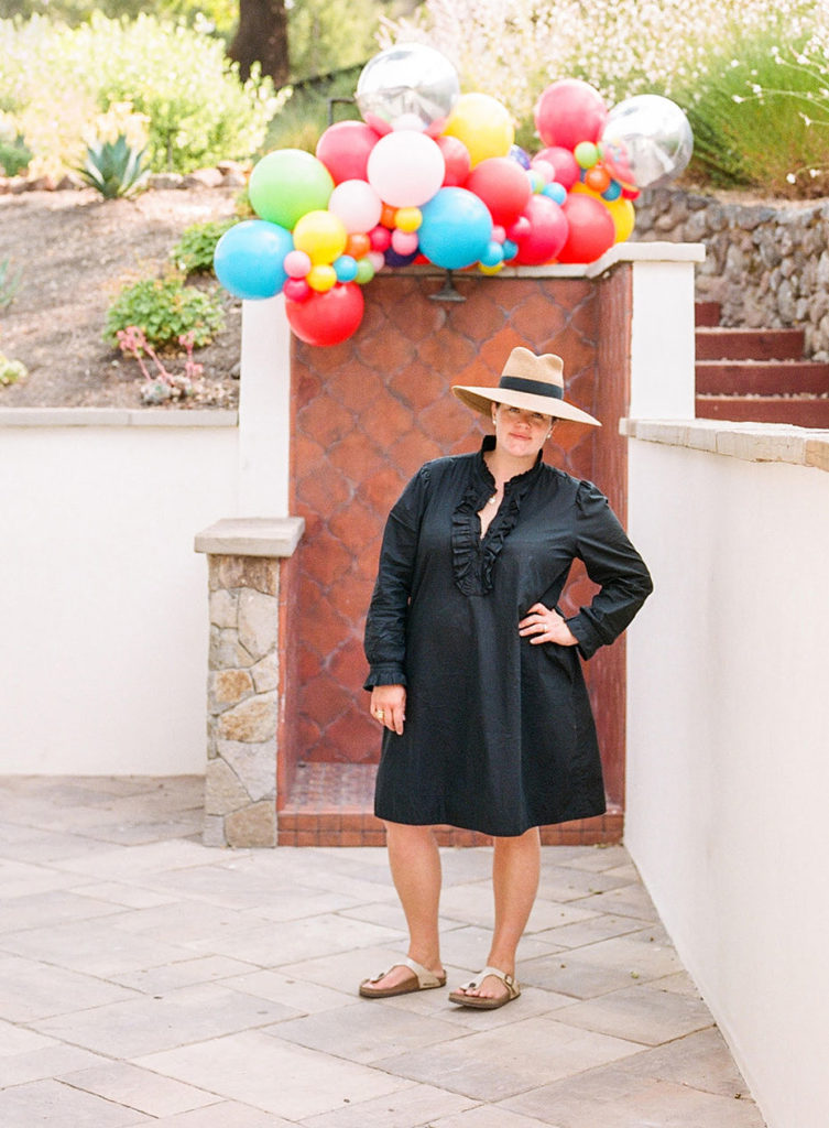 Kate Siegel standing under balloons at an event